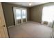 Bedroom featuring neutral walls, carpet and three windows bringing in lots of light at 4055 Vista Point Ln, Suwanee, GA 30024