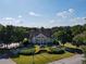 Exterior shot of the community clubhouse with manicured landscaping and ample parking at 4055 Vista Point Ln, Suwanee, GA 30024