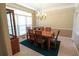 Traditional dining room featuring a chandelier, and large windows overlooking a landscaped yard at 4055 Vista Point Ln, Suwanee, GA 30024