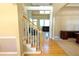 Inviting home foyer featuring hardwood floors and a staircase with carpet runner at 4055 Vista Point Ln, Suwanee, GA 30024