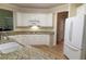 Well-lit kitchen featuring granite countertops, white cabinets, and stainless steel appliances at 4055 Vista Point Ln, Suwanee, GA 30024