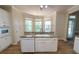 Kitchen island featuring granite countertops, white cabinets, sink and stainless steel dishwasher at 4055 Vista Point Ln, Suwanee, GA 30024