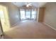 Spacious main bedroom featuring carpet, a ceiling fan, and bright natural light at 4055 Vista Point Ln, Suwanee, GA 30024