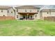 Home's backyard featuring a covered patio and spacious lawn at 5601 Savannah River Rd, Atlanta, GA 30349