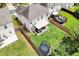 Aerial view of a backyard featuring a trampoline, patio, and green lawn with a privacy fence at 5601 Savannah River Rd, Atlanta, GA 30349