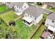 Aerial view of the home's backyard with covered patio, green lawn, trampoline and a privacy fence at 5601 Savannah River Rd, Atlanta, GA 30349