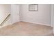 Unfinished basement with neutral carpet and white walls is ready for customization at 5601 Savannah River Rd, Atlanta, GA 30349