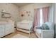 A Bedroom with a white crib, changing table, and soft pink accents, creating a serene and inviting atmosphere at 5601 Savannah River Rd, Atlanta, GA 30349