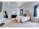 Spacious main bedroom with tray ceilings, luxurious bed, and modern decor, offering a comfortable retreat at 5601 Savannah River Rd, Atlanta, GA 30349