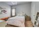 Cozy bedroom featuring a decorative headboard, plush bedding, modern light fixture, and neutral color palette at 5601 Savannah River Rd, Atlanta, GA 30349