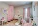 A bedroom featuring playful decor, a slide, and pink accents for a cozy, imaginative space at 5601 Savannah River Rd, Atlanta, GA 30349