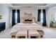 Elegant main bedroom with tray ceilings, plush bedding, and dark curtains, creating a serene retreat at 5601 Savannah River Rd, Atlanta, GA 30349