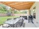 Home's covered patio, perfect for outdoor entertaining with its dining and seating areas at 5601 Savannah River Rd, Atlanta, GA 30349