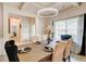 Elegant dining room with a modern chandelier, stylish wallpaper and an elegant wooden table at 5601 Savannah River Rd, Atlanta, GA 30349