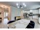 Open concept featuring modern light fixtures, kitchen island, and dining area at 5601 Savannah River Rd, Atlanta, GA 30349