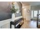 Stylish foyer with modern decor, a round mirror, and elegant lighting fixtures at 5601 Savannah River Rd, Atlanta, GA 30349