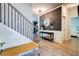 Hallway view with staircase, modern console table, and stylish decor leading to other rooms at 5601 Savannah River Rd, Atlanta, GA 30349