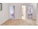 Hallway with doorways leads to multiple bedrooms, all with neutral paint and carpet at 5601 Savannah River Rd, Atlanta, GA 30349