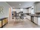 Bright kitchen featuring white cabinets, stainless steel appliances, island with seating, and unique sideboard at 5601 Savannah River Rd, Atlanta, GA 30349