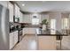 Beautiful kitchen with white cabinets, dark countertops, stainless steel appliances, and island with bar seating at 5601 Savannah River Rd, Atlanta, GA 30349