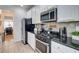 Updated kitchen showcasing granite countertops, stainless steel appliances, and a gas range at 5601 Savannah River Rd, Atlanta, GA 30349