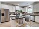 Bright kitchen showcasing granite countertops, stainless steel appliances, and island with bar seating at 5601 Savannah River Rd, Atlanta, GA 30349