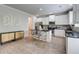 Bright kitchen featuring white cabinets, stainless steel appliances, island with seating, and unique sideboard at 5601 Savannah River Rd, Atlanta, GA 30349