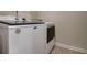 Laundry room showcasing a modern white Maytag washer and dryer set with durable, light-colored flooring at 5601 Savannah River Rd, Atlanta, GA 30349