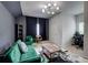 Stylish living room featuring a green velvet sofa, unique lighting, and a modern rug for a chic space at 5601 Savannah River Rd, Atlanta, GA 30349
