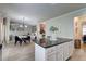 Open concept featuring kitchen island and view of living and dining areas at 5601 Savannah River Rd, Atlanta, GA 30349