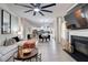 Bright living room with fireplace, ceiling fan, and open concept layout to kitchen and dining area at 5601 Savannah River Rd, Atlanta, GA 30349
