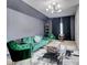 Modern living room with a green velvet sofa, stylish lighting, and eclectic decor for a comfortable and chic space at 5601 Savannah River Rd, Atlanta, GA 30349