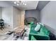 Eclectic living room featuring a green sofa, unique decor, and modern lighting for a comfortable yet stylish space at 5601 Savannah River Rd, Atlanta, GA 30349