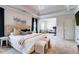 Bright main bedroom featuring tray ceilings, a sitting area, and ensuite access at 5601 Savannah River Rd, Atlanta, GA 30349