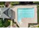 Overhead view of a neighborhood pool with sun deck, multiple swim lanes, and lush green landscaping at 5601 Savannah River Rd, Atlanta, GA 30349