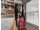 Organized walk-in closet with custom shelving and a window for natural light at 5601 Savannah River Rd, Atlanta, GA 30349