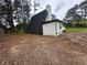 A large yard, complete with mature trees, surrounds this uniquely designed home at 6774 Collier Rd, Riverdale, GA 30296