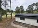 This home is surrounded by beautiful mature trees, creating a park-like feel at 6774 Collier Rd, Riverdale, GA 30296