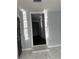 Hallway with light walls, marble floors, black doors, and a step-up entry to another room at 6774 Collier Rd, Riverdale, GA 30296