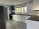 Modern kitchen with white cabinets, subway tile backsplash, stainless steel appliances, and marble floors at 6774 Collier Rd, Riverdale, GA 30296