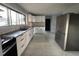 Modern kitchen with white cabinets, stainless steel appliances, subway tile backsplash, and marble floors at 6774 Collier Rd, Riverdale, GA 30296