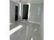 This room features light walls, marble floors, black doors, and trim with a step-up entry at 6774 Collier Rd, Riverdale, GA 30296