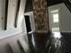 Living room featuring a stone fireplace, dark wood floors, and an open doorway to another room at 6774 Collier Rd, Riverdale, GA 30296