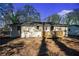 Backyard featuring a small wood deck, a grassy lawn, and a detached garage at 904 Fairburn Nw Pl, Atlanta, GA 30331
