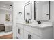 Bright bathroom with double vanity, quartz countertop, black hardware, and a bedroom view at 904 Fairburn Nw Pl, Atlanta, GA 30331