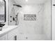 Contemporary bathroom with a marble tiled shower featuring designer black fixtures at 904 Fairburn Nw Pl, Atlanta, GA 30331