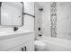 Bathroom with marble-look tiles, built-in shower niche, and modern black fixtures over a tub at 904 Fairburn Nw Pl, Atlanta, GA 30331