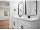 Stylish bathroom vanity with double sinks, modern faucets, white cabinets, and black hardware at 904 Fairburn Nw Pl, Atlanta, GA 30331