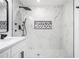 Modern bathroom with a glass enclosed shower, marble tiling, and a contrasting rectangular shower niche at 904 Fairburn Nw Pl, Atlanta, GA 30331