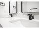 Modern bathroom with a double sink vanity featuring black faucets and framed mirrors at 904 Fairburn Nw Pl, Atlanta, GA 30331